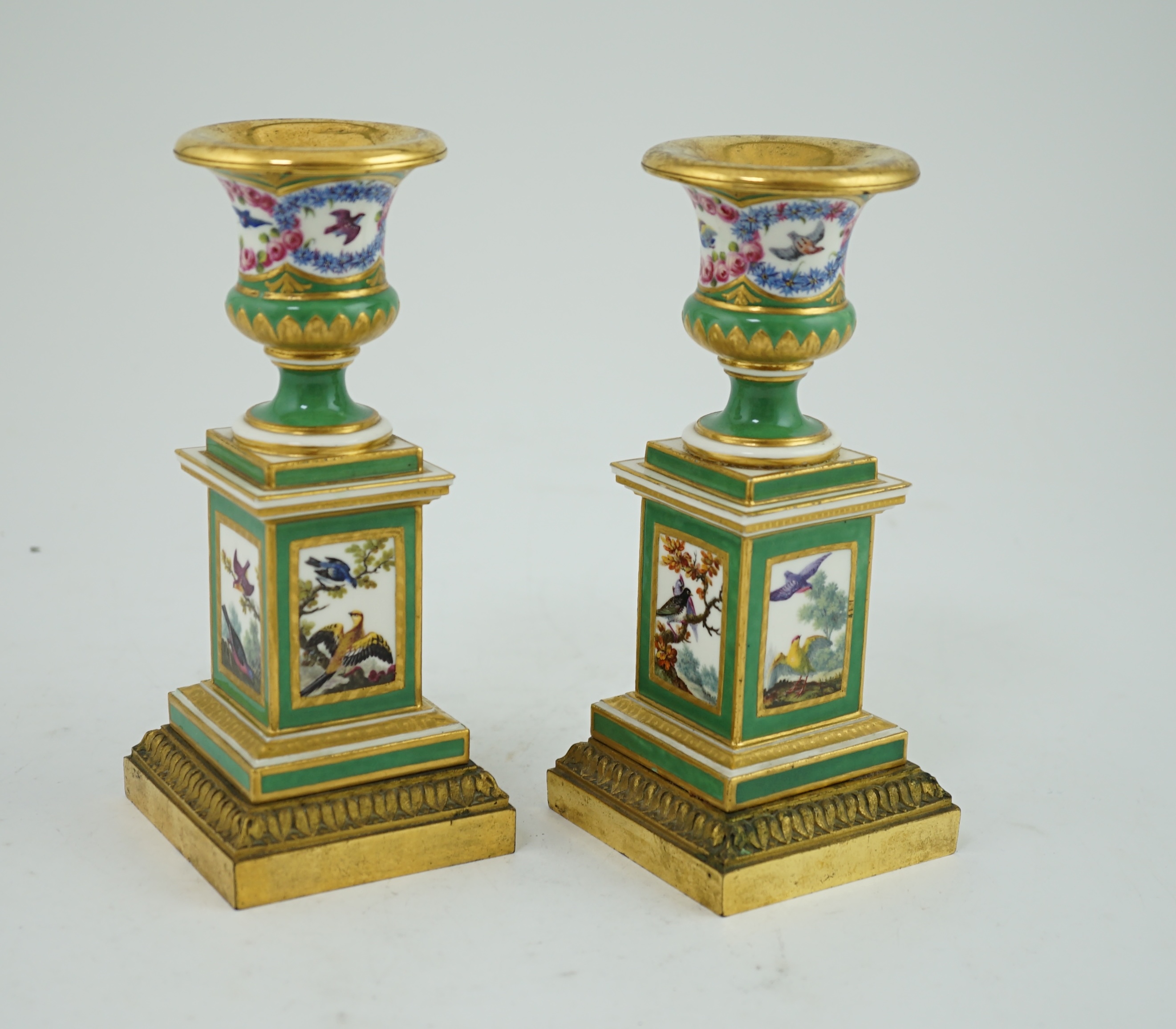 A pair of late 18th century Sevres ormolu mounted porcelain candlesticks, in the manner of Chappuis L'Aine